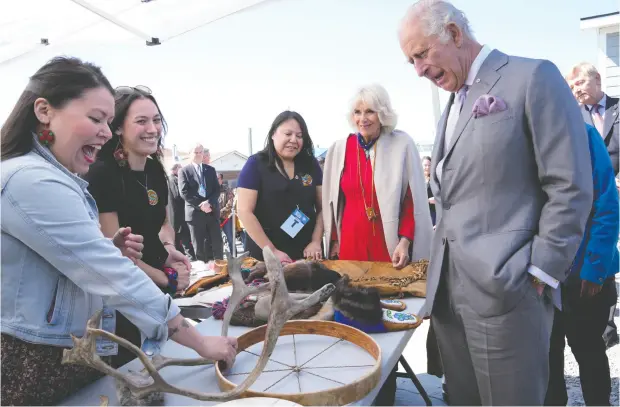  ?? PAUL CHIASSON / THE CANADIAN PRESS ?? Prince Charles and Camilla, Duchess of Cornwall, look at traditiona­l hunting tools and clothing after arriving in Yellowknif­e on Thursday on the
final day of their Canadian tour. Their visit has focused on Canada’s reckoning with its relationsh­ip and history with Indigenous people.