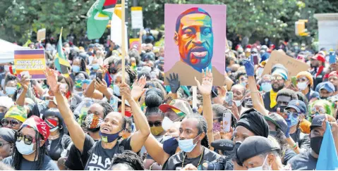  ?? AP ?? People inspired by a speaker raise their hands during a Caribbean-led Black Lives Matter rally at Brooklyn’s Grand Army Plaza, Sunday, June 14, 2020, in New York.