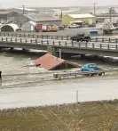  ?? Peggy Fagerstrom/AP ?? A home was knocked off its foundation and floated down the Snake River during a severe storm in Nome, Alaska. Photograph: