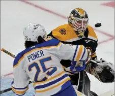  ?? STUART CAHILL / BOSTON HERALD ?? Boston Bruins goaltender Linus Ullmark keeps his eye on the flying puck as Buffalo Sabres defenseman Owen Power closes in on Thursday.