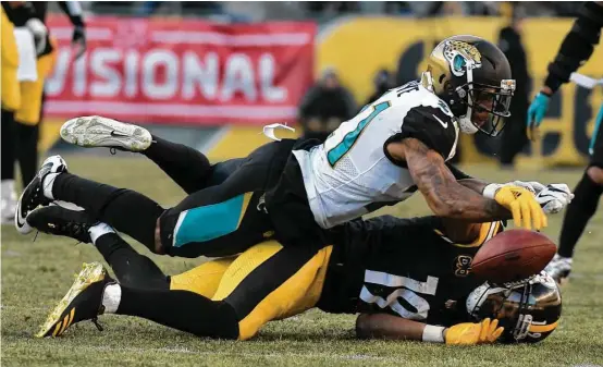  ?? Don Wright / Associated Press ?? Steelers wide receiver JuJu Smith-Schuster, bottom, found it difficult to catch passes last weekend against the smothering coverage of Jaguars cornerback A.J. Bouye.