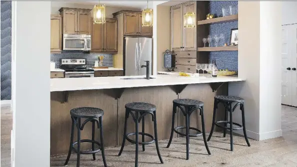  ??  ?? The kitchen of the Vasi 2 from Hopewell Residentia­l features a 10-foot-long eating bar, providing plenty of room for seating.