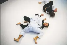  ?? NATHAN BURTON/Taos News ?? Left: Julia Struck, top, grapples an opponent during practice on Saturday (April 9) at Jess Jacquez BJJ in Taos. RIght: Demitrius Medina, top, attempts to pin Kristin Brudevold during practice.
