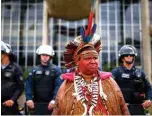  ??  ?? In this file photo a Brazilian indigenous leader takes part in a protest demanding the demarcatio­n of indigenous lands, in Brasilia.