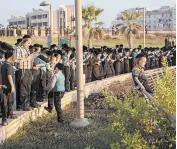  ?? ARIEL SCHALIT/AP ?? Ultra-Orthodox Jews pray on a hill overlookin­g the Mediterran­ean Sea on Thursday in Netanya, Israel. New restrictio­ns to counter the coronaviru­s will affect religious activities.