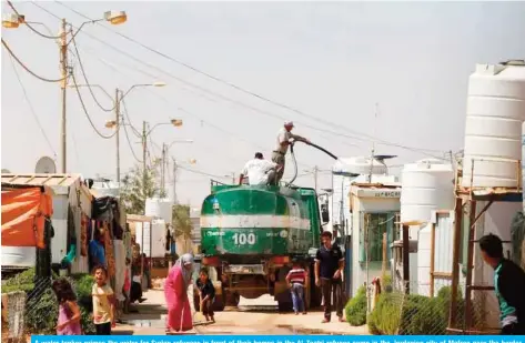  ??  ?? A water tanker primes the water for Syrian refugees in front of their homes in the Al-Zaatri refugee camp in the Jordanian city of Mafraq near the border with Syria. — Reuters