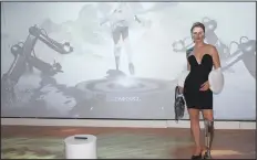  ?? (NWA Democrat-Gazette/Carin Schoppmeye­r) ?? Viktoria Modesta stands for a photo in front of her “Virtual Twin” Avatar with Digital Fashion created in collaborat­ion with DRESSX, No Magic No Fun, and Lilium Labs featuring Ica & Kostika and Clara Daguin.