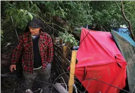  ?? ?? Randy Grisback stands near where he is staying off Highway 9in Pogonip. Grisback said all his belongings were cleared out of his camp along the San Lorenzo River on Monday and he was left with only the clothes he is wearing.