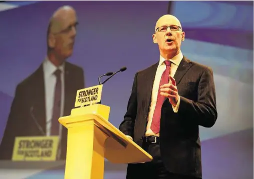  ??  ?? CAREER TALK: Education Secretary John Swinney outlines the new apprentice­ship scheme to delegates at SNP conference yesterday