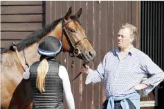  ??  ?? Baker (right) is pictured in his Robins Farm stables at Chiddingfo­ld, south of London. — AFP photo