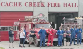  ?? JEFF BASSETT/THE CANADIAN PRESS ?? Firefighte­rs stand in front of the fire hall as they welcome back residents to Cache Creek, B.C., on July 18. Residents were allowed back after being evacuated due to wildfires. The area is still blanketed with thick smoke.