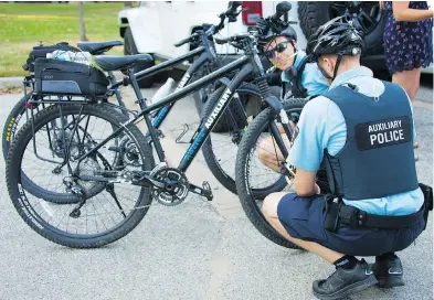  ?? TAYLOR CAMPBELL ?? Windsor Police auxiliary officers put glow sticks on their wheels during the Friday Night Lights ride July 13.