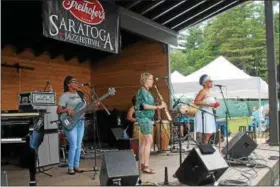  ??  ?? Jane Bunnett and Maqueque performing to a crowd at the 40th annual Freihofer’s Saratoga Jazz Festival at Saratoga Performing Arts Center.