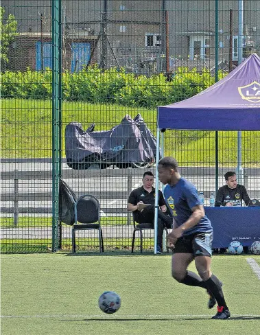  ??  ?? California calling: LA Galaxy coaches look on as hopefuls go through their paces at Barnet; trialist Kyle Rennock from Croydon (right); the list of wannabes (left); and star signing Ashley Cole (far left)