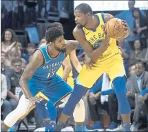  ?? J PAT CARTER — GETTY IMAGES ?? Thunder defender Paul George applies pressure as the Warriors’ Kevin Durant looks for a shot during Tuesday’s game. The Warriors won 111-107.