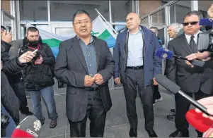  ?? CP PHOTO ?? Johannes Lampe, left, president of the Nunatsiavu­t Government, talks to the media as Todd Russell, president of NunatuKavu­t, looks on at a Muskrat Falls demonstrat­ion on the steps of the Confederat­ion Building in St. John’s in this 2016 file photo.