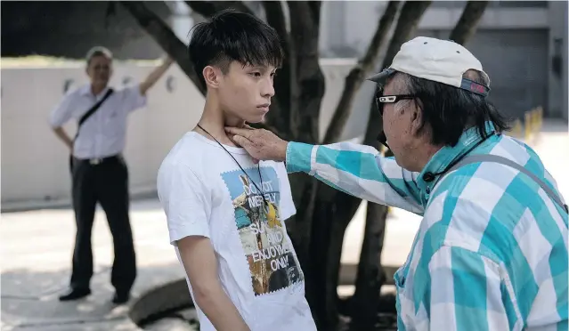  ?? ALEX OGLE/ AFP/ GETTY IMAGES ?? A man jabs his fi ngers in the throat of a pro- democracy protester Monday in Hong Kong, which has been plunged into the worst political crisis since its 1997 handover to China from the British .