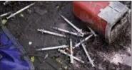  ?? CHARLES KRUPA — THE ASSOCIATED PRESS ?? This Wednesday, June 7, 2017 photo shows discarded used hypodermic needles without protective sheaths at an encampment where opioid addicts shoot up along the Merrimack River in Lowell, Mass.