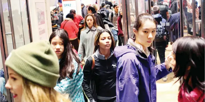  ??  ?? NEW YORK: Shoppers walk out of Uniqlo on 666 5th Avenue in New York City on Black Friday. Although Black Friday sales are expected to be strong, many shoppers are opting to buy online or retailers are offering year round sales and other incentives that...