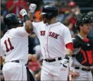  ?? AP PHOTO/ MICHAEL DWYER ?? Boston Red Sox’s J.D. Martinez, center, celebrates his solo home run with teammate Rafael Devers (11) as Baltimore Orioles’ Andrew Susac looks away during the second inning of a baseball game in Boston, Sunday, May 20, 2018.