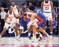  ?? Carlos Osorio / Associated Press ?? Knicks guard Alec Burks steals the ball from Pistons guard Cade Cunningham (2) during the second half Sunday.