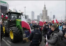  ?? CZAREK SOKOLOWSKI — ASSOCIATED PRESS FILE ?? Polish farmers protest against European Union green policies that trim their production and against cheap grain and other food imports from Ukraine, in February in Warsaw.