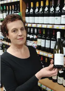  ?? Photo: Eamonn Keogh ?? Wine columnist Katherine Donnelly with a bottle of Chateau de Tracy at The Carry Out Off Licence in Killarney.