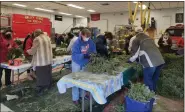  ?? SUBMITTED PHOTO ?? Volunteers work to recycle 500 wreaths that had been on display at Valley Forge National Historic Park as part of Wreaths Across America.