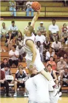  ?? MATT STRASEN ?? Former Oklahoma Christian School star Blake Griffin leaps over a group of teammates during the slam dunk competitio­n before the Faith 7 basketball game in 2007.