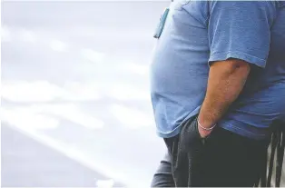  ?? PAUL ELLIS/AFP/GETTY IMAGES ?? A man with a waist more than 40 inches is at higher risk for health issues.