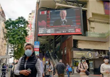  ??  ?? A TV screen broadcasts the news of the inaugurati­on of US President Joe Biden at a shopping mall in Hong Kong, on Thursday. — AP