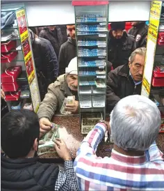  ??  ?? Buying lottery tickets at the Nimet Abla lottery stand.