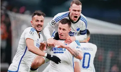  ?? Photograph: Ritzau Scanpix Denmark/Reuters ?? Copenhagen's Lukas Lerager is mobbed by teammates after his goal secured their progress into the knockout stages of the Champions League.