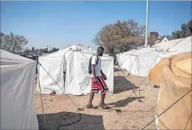  ??  ?? Uprooted: Abdullah Sulieman (above left) is among the former residents of the burned-down Cape York building and the hijacked Fattis Mansions who were moved to the Wembley Stadium temporary camp from the Johannesbu­rg city centre, where many had eked...