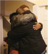  ??  ?? CHICAGO: Melvin Jones, facing camera, hugs Robin Andrews, both brothers of Bettie Jones, 55, in Jones’ living room after she was shot and killed by a Chicago police officer on Saturday December 26, 2015. — AP