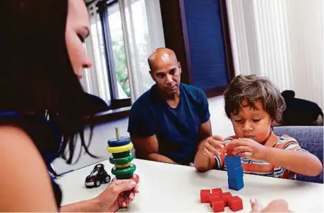  ?? Washington Post ?? Speech pathologis­t Glendys Sanchez performs a developmen­t evaluation with 2-year-old Namine Andino as his father, Miguel Andino, watches at the Early Steps programme clinic at the University of Miami.