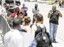  ?? Jon Shapley / Staff photograph­er ?? Ashton Woods, co-founder of Black Lives Matter Houston, leads a protest over the fatal police shooting of Rayshard Scales.