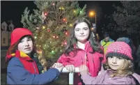  ?? Photograph: Iain Ferguson, The Write Image ?? From left, Skye Strachan, nine, of St Columba’s, Ella Welsh, 11, Bun Sgoil Gaidhlig, and Natalie Murray, seven, of Banavie Primary switch on the Christmas lights.