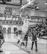  ?? Tim Godbee ?? Peyton Law drives down the lane and launches a shot for two of his 15 points during Calhoun’s battle with Cartersvil­le that went into double overtime en route to a 57-52 Yellow Jacket win.