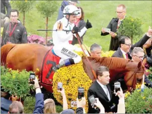  ?? AFP ?? Jockey Mike Smith and Justify enter the winner’s circle at the 143rd Preakness Stakes on Saturday in Baltimore, Maryland.