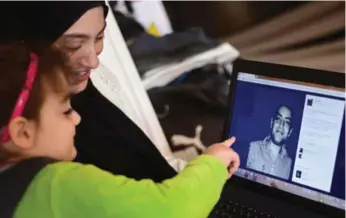  ?? MOHAMED EL-SHAHED/AFP/GETTY IMAGES ?? Baher Mohamed’s imprisonme­nt has taken a harsh toll on his wife, Jehane Rashed, seen with one of their children.