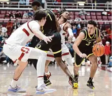  ?? Nic Coury/Associated Press ?? Oregon guard Jackson Shelstad drives on Stanford’s Maxime Raynaud during the second half Thursday at Maples Pavilion.