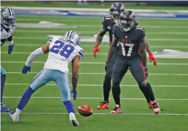  ?? AP PHOTO/RON JENKINS ?? Dallas Cowboys cornerback C.J. Goodwin (29) tracks the football after his team’s onside kick as the Atlanta Falcons’ Olamide Zaccheaus (17) looks on late in the game on Sept. 20 in Arlington, Texas. Goodwin recovered the kick, and the Cowboys made a field goal to win as the Falcons completed a stunning collapse after being in command for most of the game.