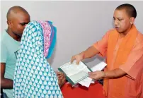  ?? PTI ?? Chief Minister Yogi Adityanath meeting the family members of martyred BSF personnel Prem Sagar in Deoria. —