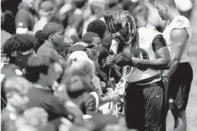  ?? JULIO CORTEZ/AP ?? Ravens linebacker Pernell McPhee signs autographs during training camp in Owings Mills.