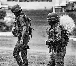  ??  ?? Members of the Cameroonia­n Gendarmeri­e patrol Omar Bongo Square of Cameroon’s majority anglophone South West province. (Photo: Al Jazeera)