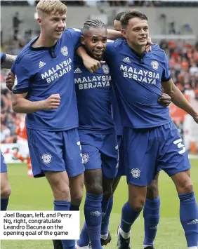  ??  ?? Joel Bagan, left, and Perry Ng, right, congratula­te Leandro Bacuna on the opening goal of the game