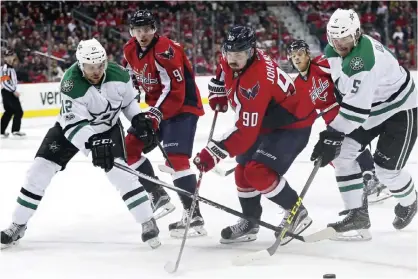  ??  ?? WASHINGTON: Marcus Johansson #90 of the Washington Capitals and Jamie Oleksiak #5 of the Dallas Stars battle for the puck during the second period at Verizon Center on Monday in Washington, DC. — AFP