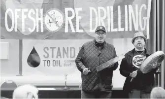  ?? AP ?? Jeff Choke, left, and Hwequidi Hanford McCloud, members of the Nisqually Indian Tribe, perform at a hearing in Olympia, Washington, organized by a coalition of environmen­tal groups opposed to the Trump administra­tion’s proposal to expand offshore oil...