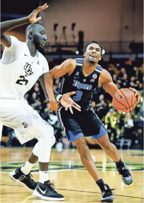  ??  ?? Memphis guard Jeremiah Martin (right) is fouled UCF center Tacko Fall (left) during action in Orlando on Saturday. MARK WEBER/THE COMMERCIAL APPEAL